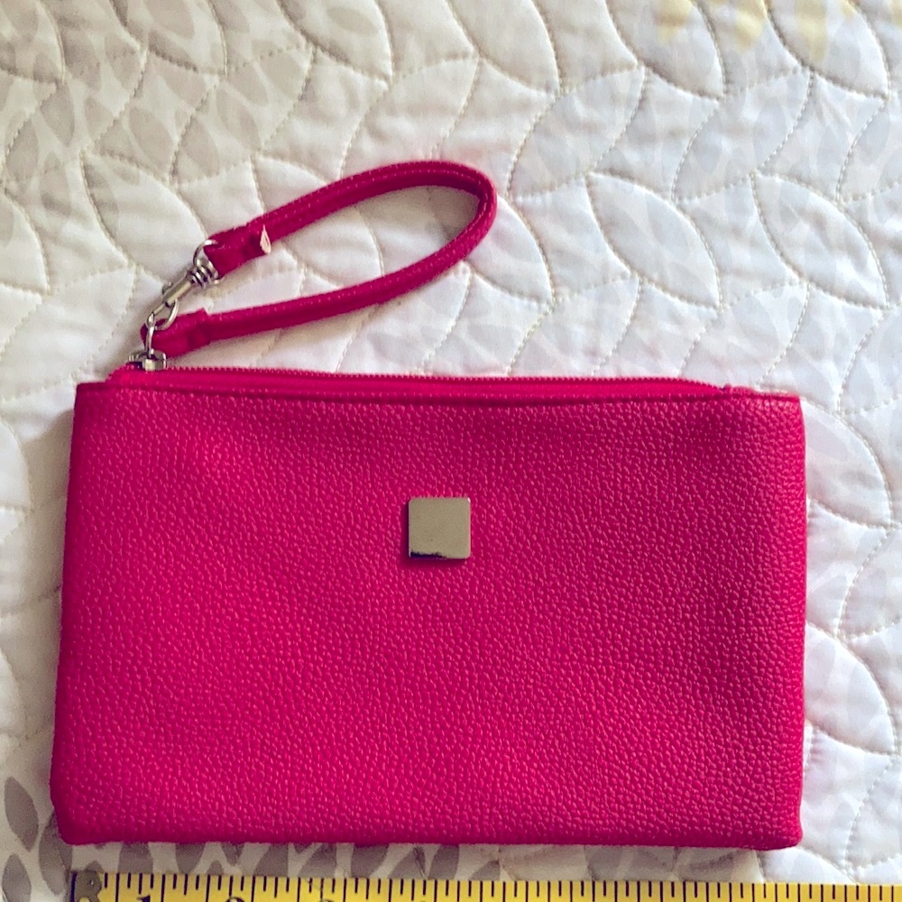 Fuchsia wristlet clutch like new. Absolutely no flaws. Never used.